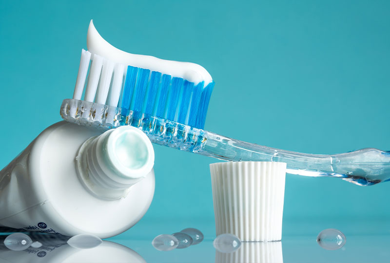 A photograph of three individuals, a man and two women, in a professional setting, seated on a couch with one woman holding an envelope while the others look at her.